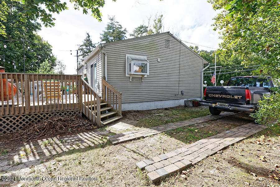 458 Dover Road Toms River, NJ 08757 - Photo 11 of 13 a view of house with a bench in patio