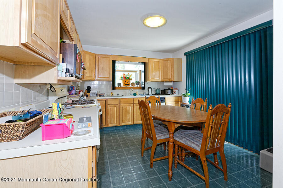 458 Dover Road Toms River, NJ 08757 - Photo 7 of 13 a dining room with a wooden table and chairs