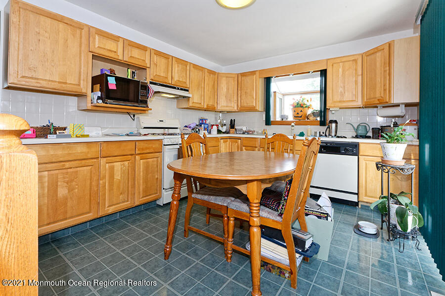 458 Dover Road Toms River, NJ 08757 - Photo 8 of 13 a kitchen with a table chairs sink and cabinets