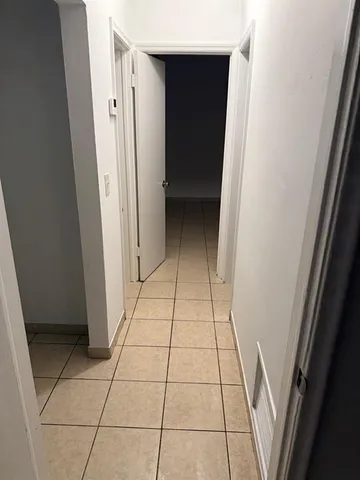 a view of an empty room with a door