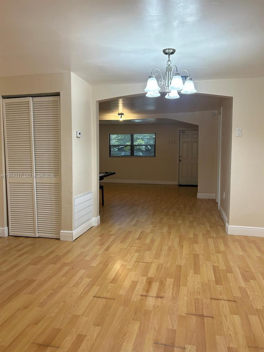 8866 Southwest 126th Street Miami, FL 33176 - Photo 20 of 20 an empty room with chandelier fan and windows