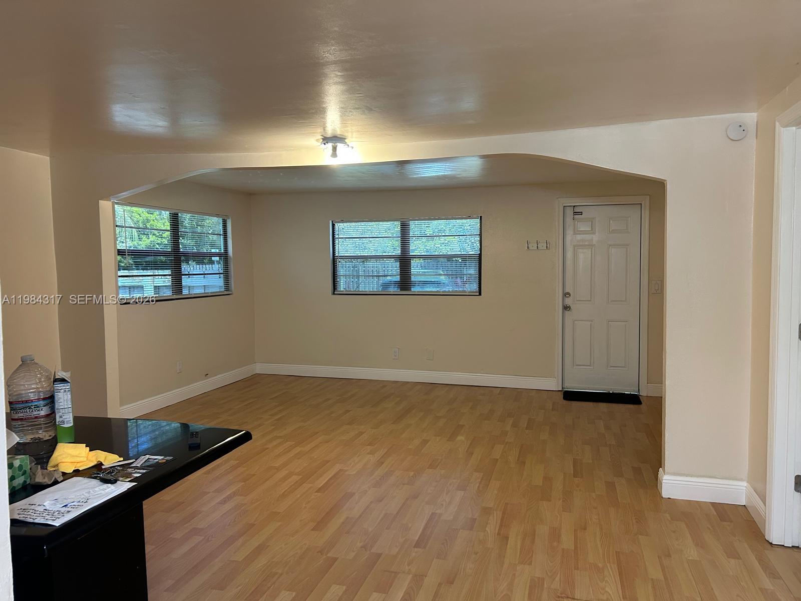 8866 Southwest 126th Street Miami, FL 33176 - Photo 3 of 20 an empty room with wooden floor and windows