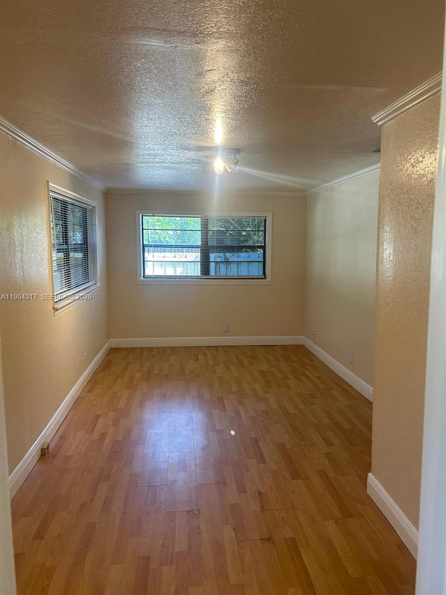 8866 Southwest 126th Street Miami, FL 33176 - Photo 9 of 20 an empty room with wooden floor and windows