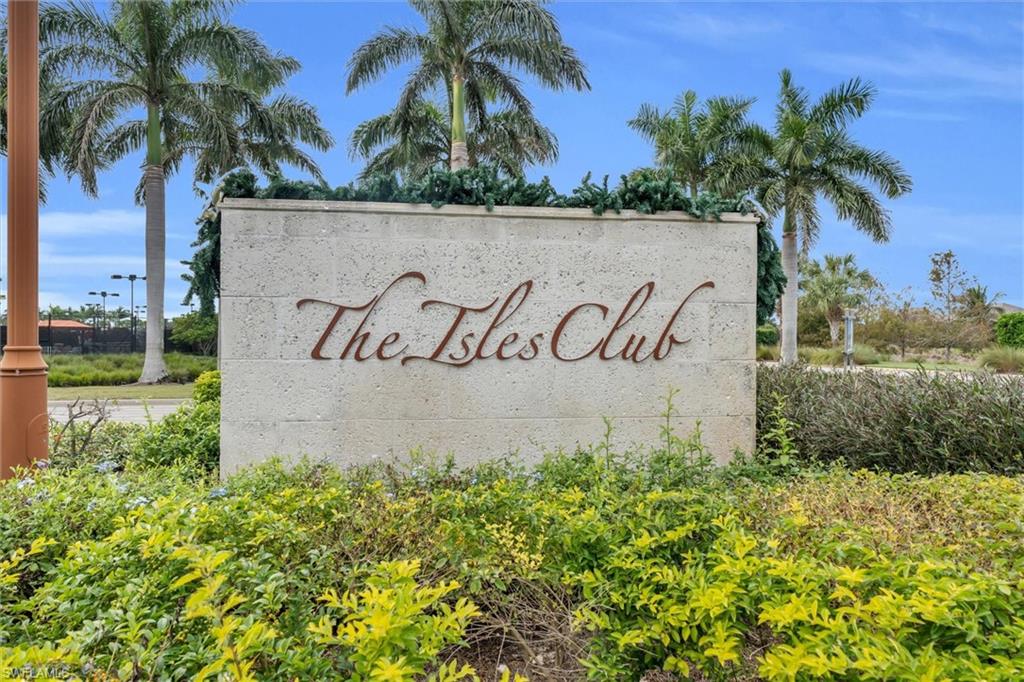 8795 Calypso Court Naples, FL 34113 - Photo 38 of 49 a sign that is on the side of the grass