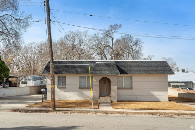 8558 South Center Street Sandy, UT 84070 - Photo 1 of 1 Dutch colonial featuring roof with shingles, mansard roof, and brick siding