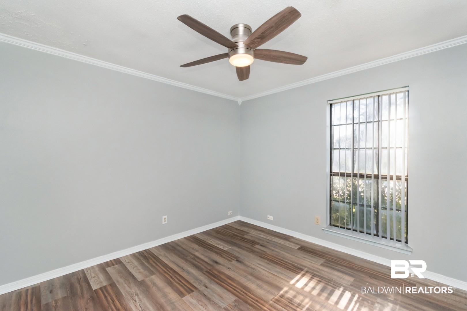 8304 Champlain Circle Mobile, AL 36695 - Photo 25 of 46 Spare room featuring hardwood / wood-style flooring, ornamental molding, and ceiling fan