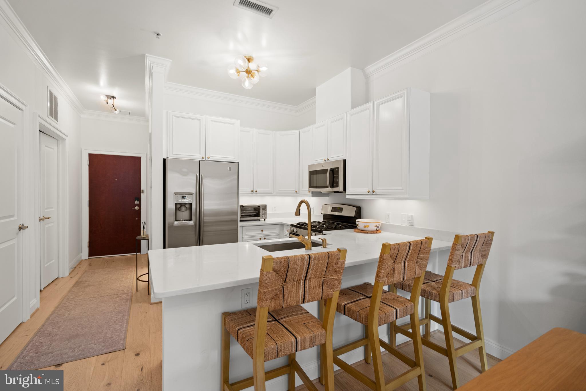 1210 R Street Northwest, Unit 213 Washington, DC 20009 - Photo 2 of 14 a kitchen with stainless steel appliances a refrigerator and microwave