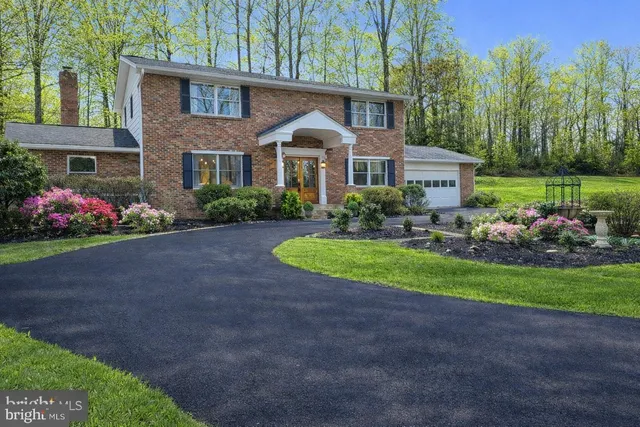 a front view of a house with a yard and outdoor seating