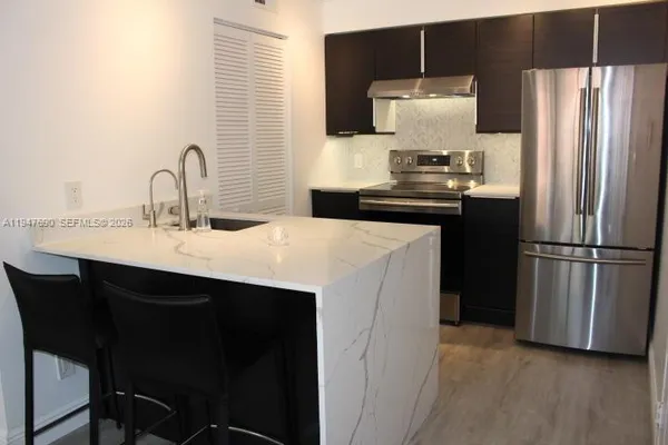 a kitchen with a sink and a refrigerator