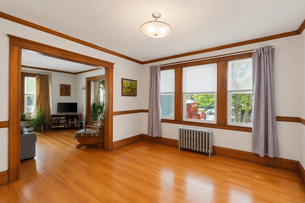 157 Elm Street Somerville, MA 02144 - Photo 2 of 19 a view of an empty room with furniture and a window