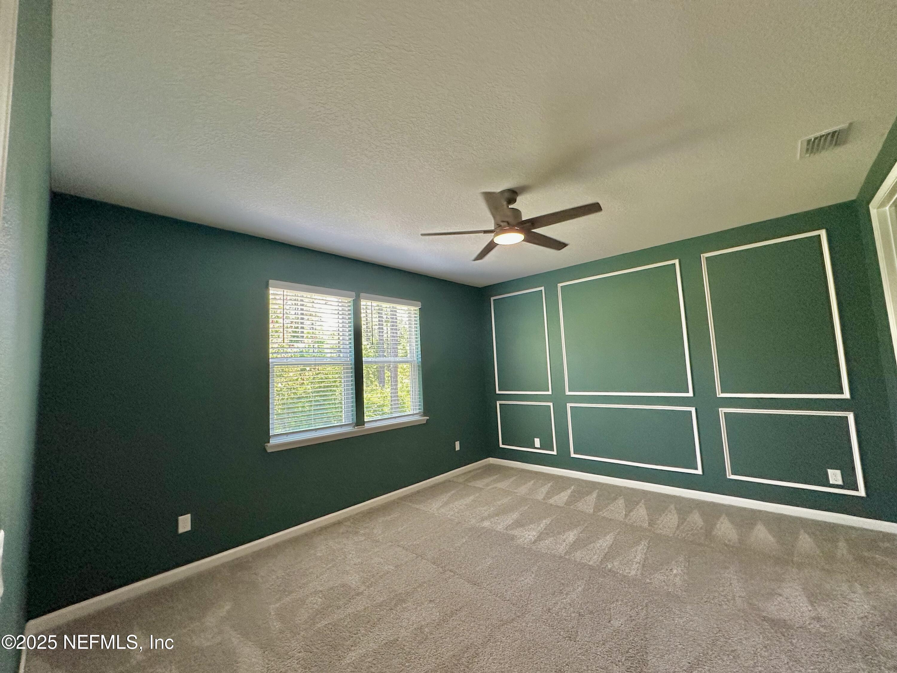 75310 White Rabbit Avenue Yulee, FL 32097 - Photo 15 of 61 a view of empty room with window and ceiling fan