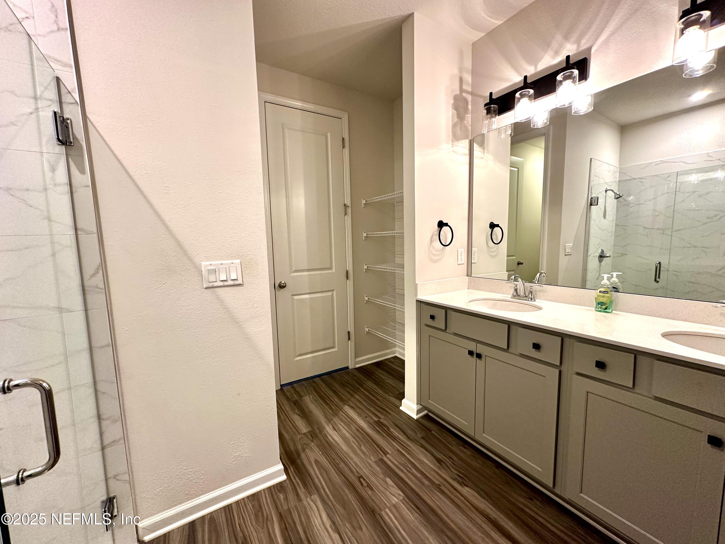 75310 White Rabbit Avenue Yulee, FL 32097 - Photo 21 of 61 a spacious bathroom with a double vanity sink a mirror and a shower