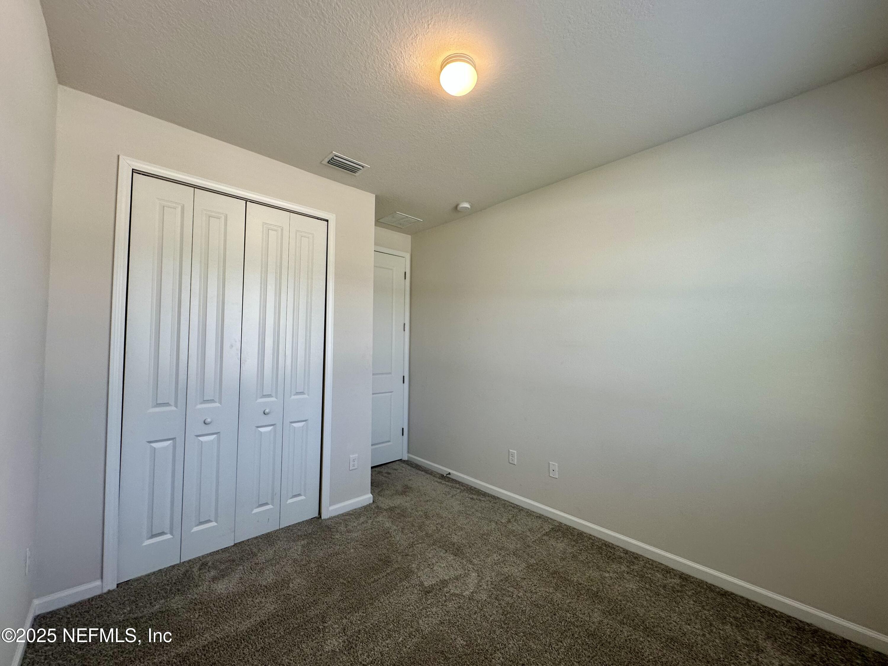 75310 White Rabbit Avenue Yulee, FL 32097 - Photo 33 of 61 an empty room with windows & cabinet