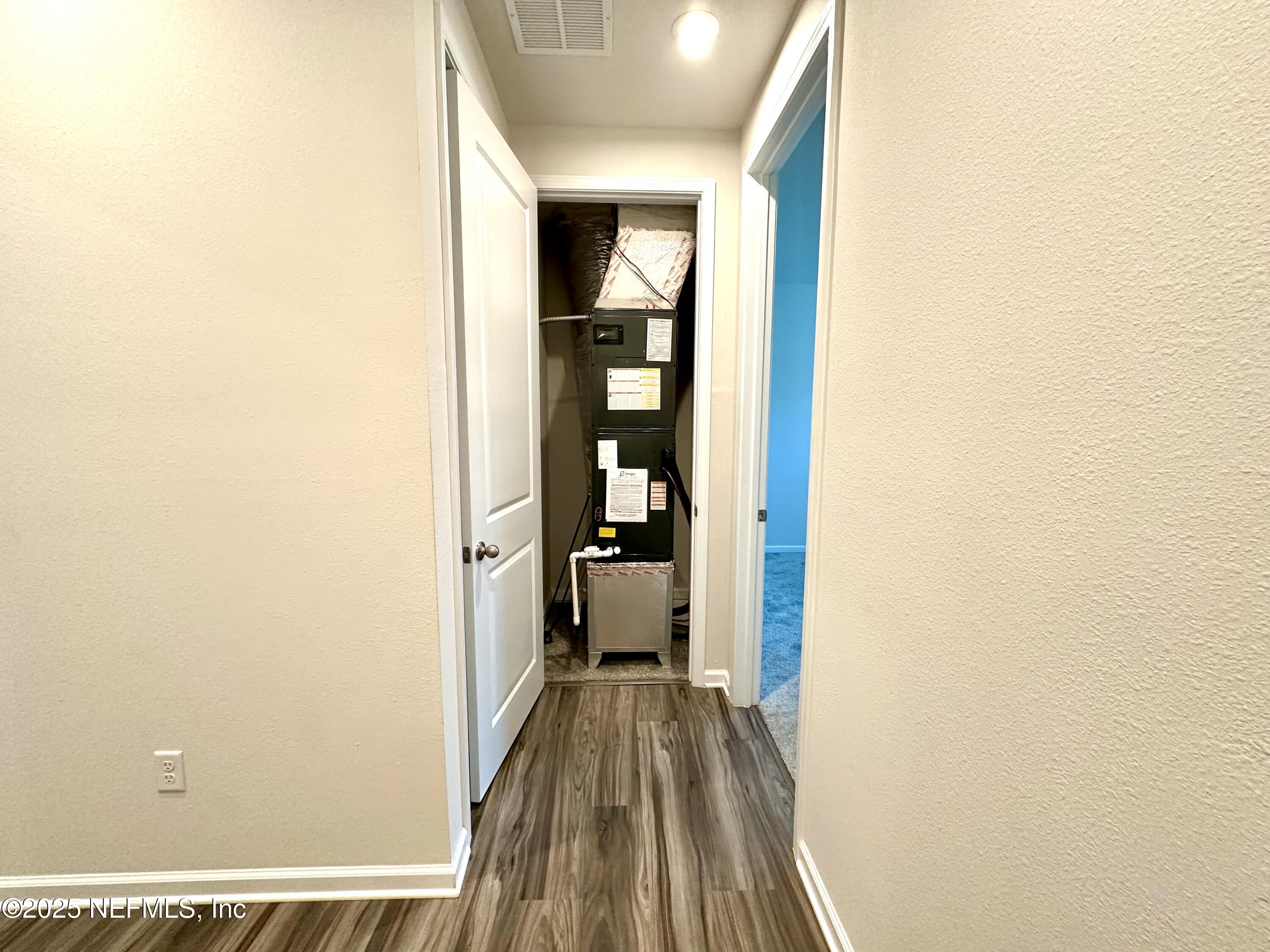 75310 White Rabbit Avenue Yulee, FL 32097 - Photo 37 of 61 a view of a hallway with wooden floor and staircase