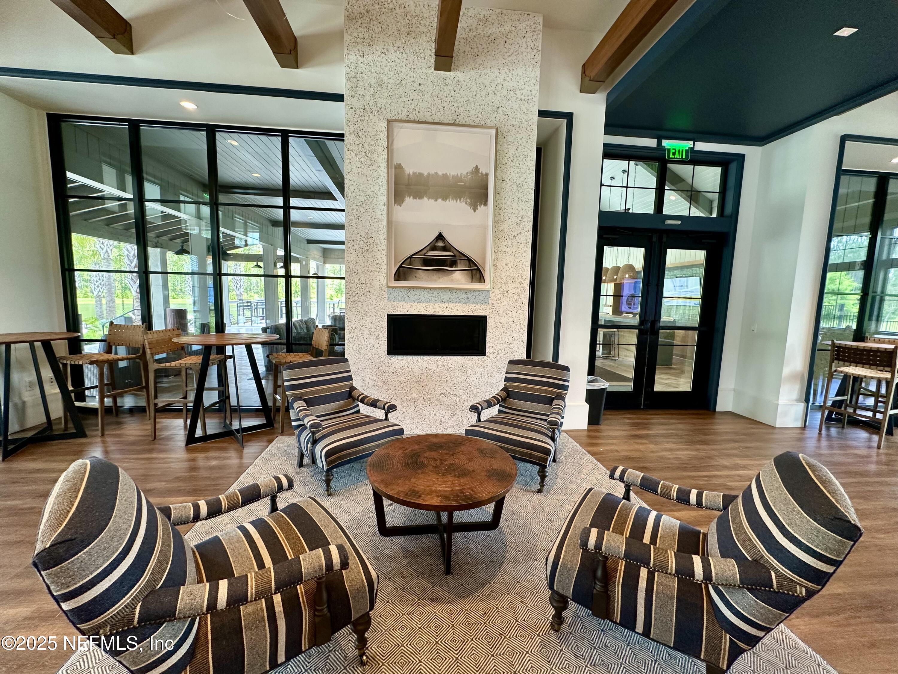75310 White Rabbit Avenue Yulee, FL 32097 - Photo 58 of 61 a living room with furniture and a floor to ceiling window