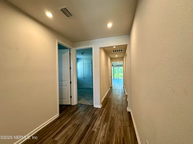 a spacious bathroom with a double vanity sink a mirror and a shower