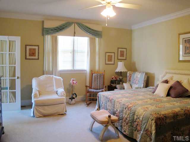 3401 Barron Berkeley Way Raleigh, NC 27612 - Photo 14 of 25 a bedroom with a bed and a couch