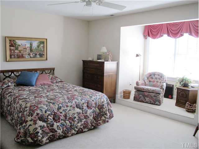 3401 Barron Berkeley Way Raleigh, NC 27612 - Photo 18 of 25 a bedroom with a bed and dresser