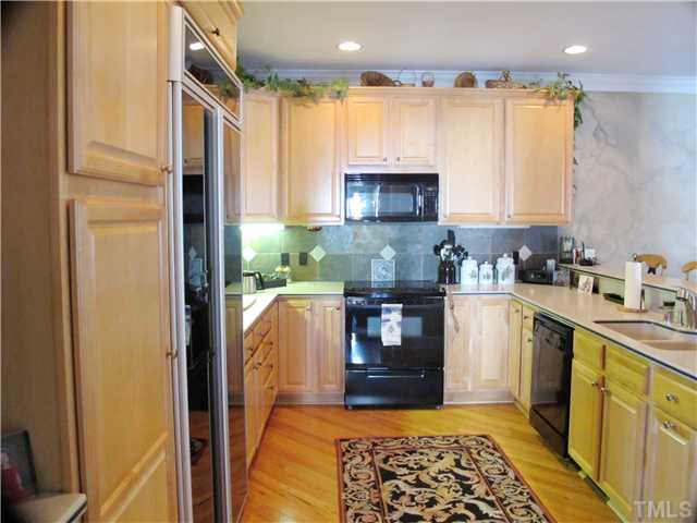 3401 Barron Berkeley Way Raleigh, NC 27612 - Photo 4 of 25 a kitchen with stainless steel appliances granite countertop a refrigerator sink and stove