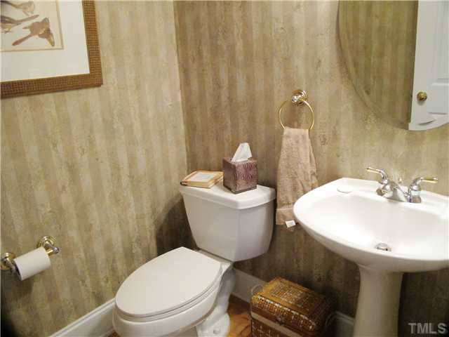 3401 Barron Berkeley Way Raleigh, NC 27612 - Photo 8 of 25 a bathroom with a toilet a sink and a shower curtain