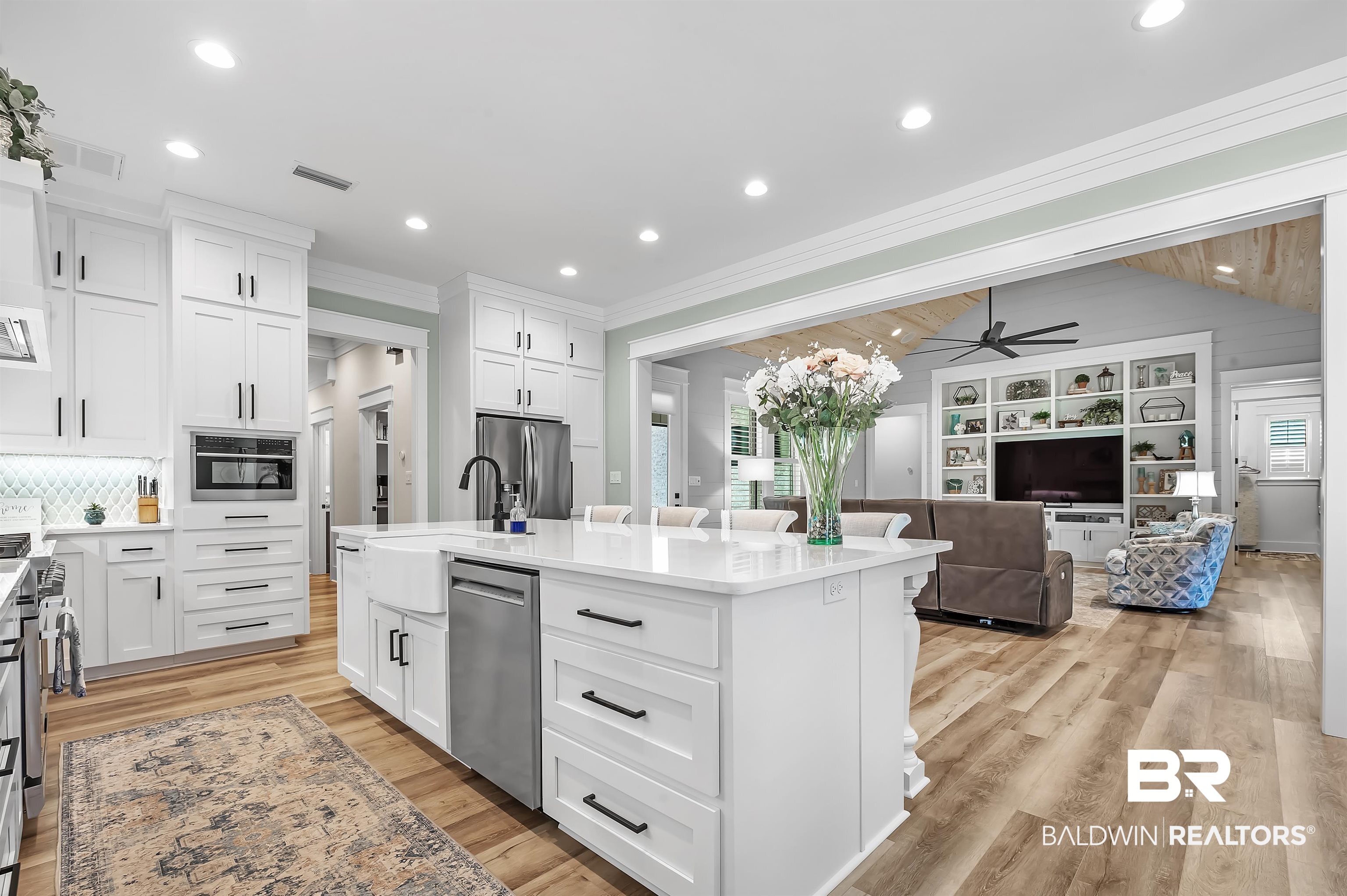 9144 Harvest Ridge Fairhope, AL 36532 - Photo 58 of 58 Kitchen with white cabinetry, a center island with sink, appliances with stainless steel finishes, and open floor plan