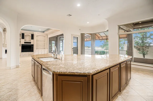 a kitchen with stainless steel appliances granite countertop a sink and cabinets
