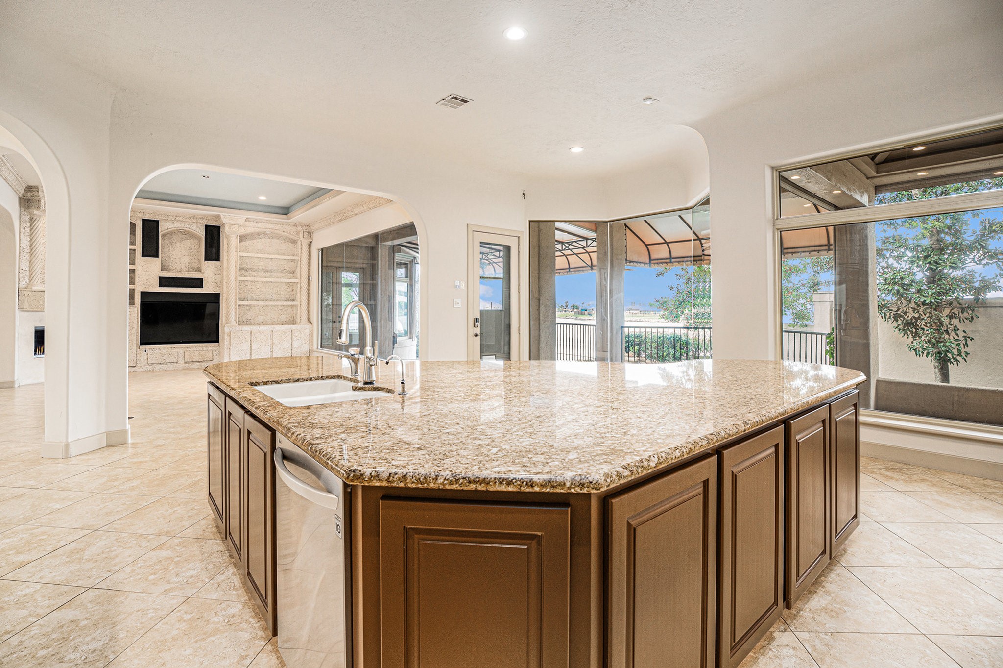 427 East Shore Drive Clear Lake Shores, TX 77565 - Photo 10 of 28 an open kitchen with granite countertop a sink and dishwasher with a dining table