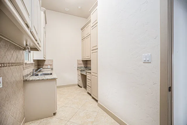 an open kitchen with granite countertop a sink and dishwasher with a dining table