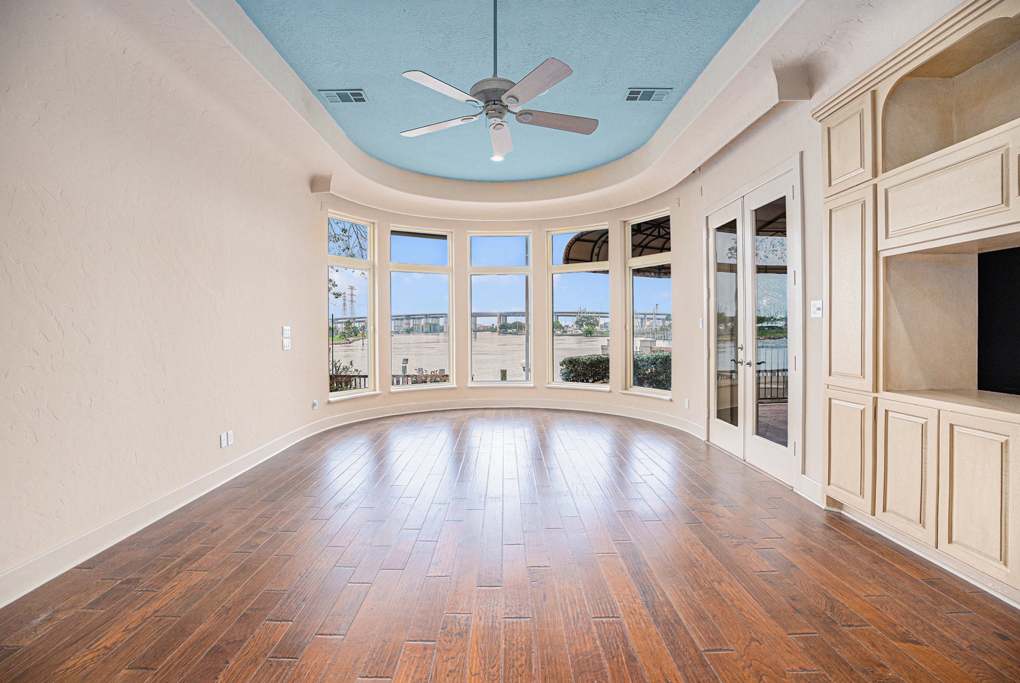 427 East Shore Drive Clear Lake Shores, TX 77565 - Photo 13 of 28 a view of an empty room with a window and wooden floor