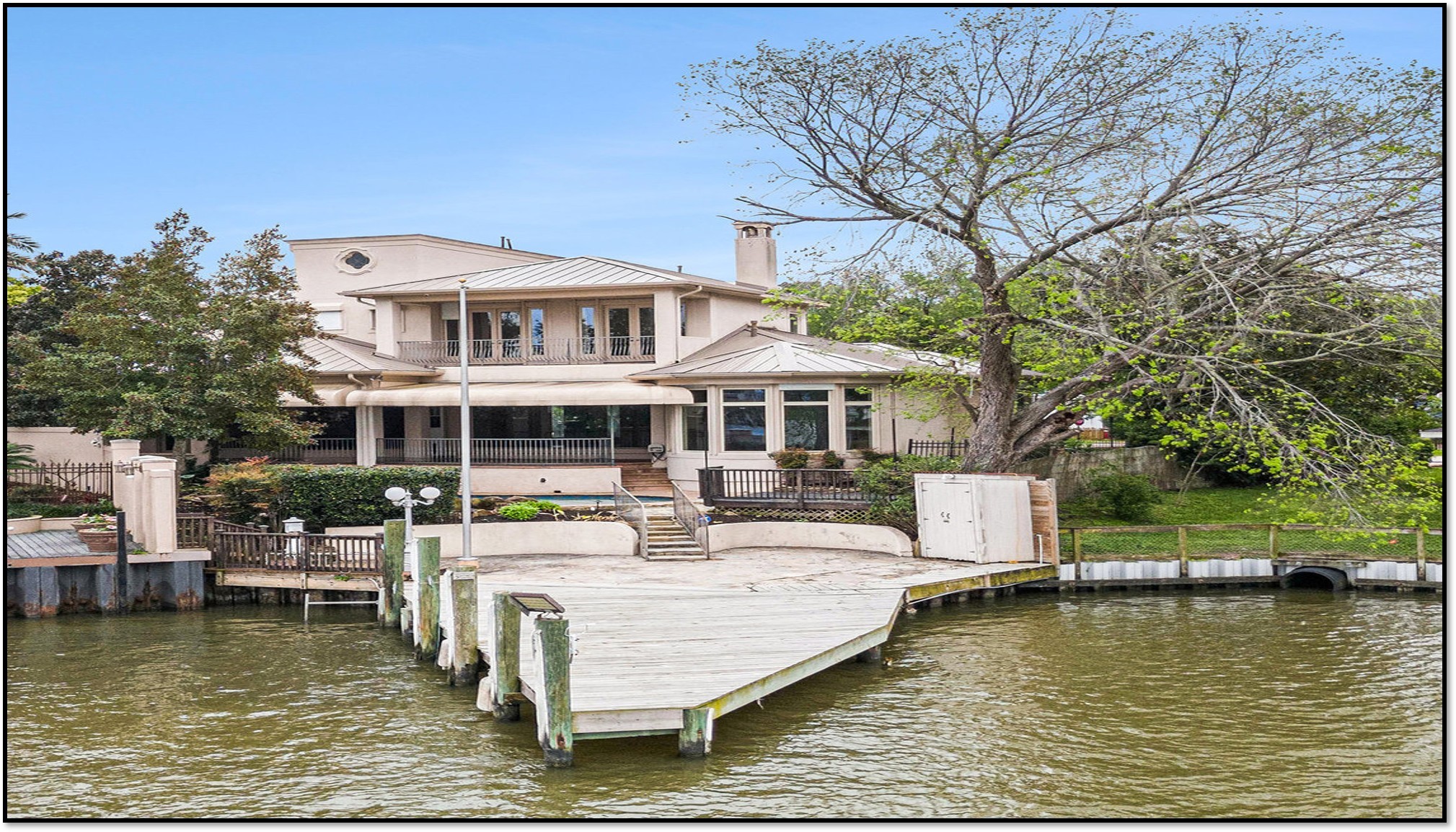 427 East Shore Drive Clear Lake Shores, TX 77565 - Photo 26 of 28 a roof deck with table and chairs and a large tree