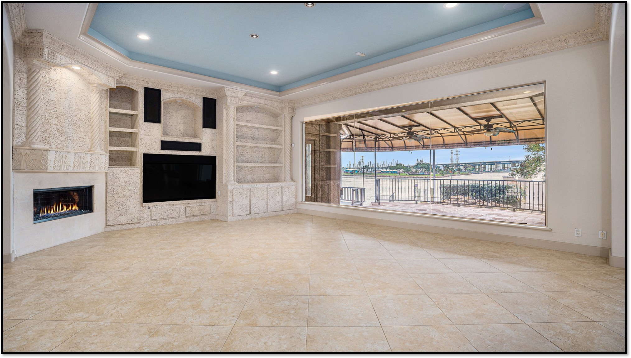 427 East Shore Drive Clear Lake Shores, TX 77565 - Photo 4 of 28 a view of empty room with a fireplace and window