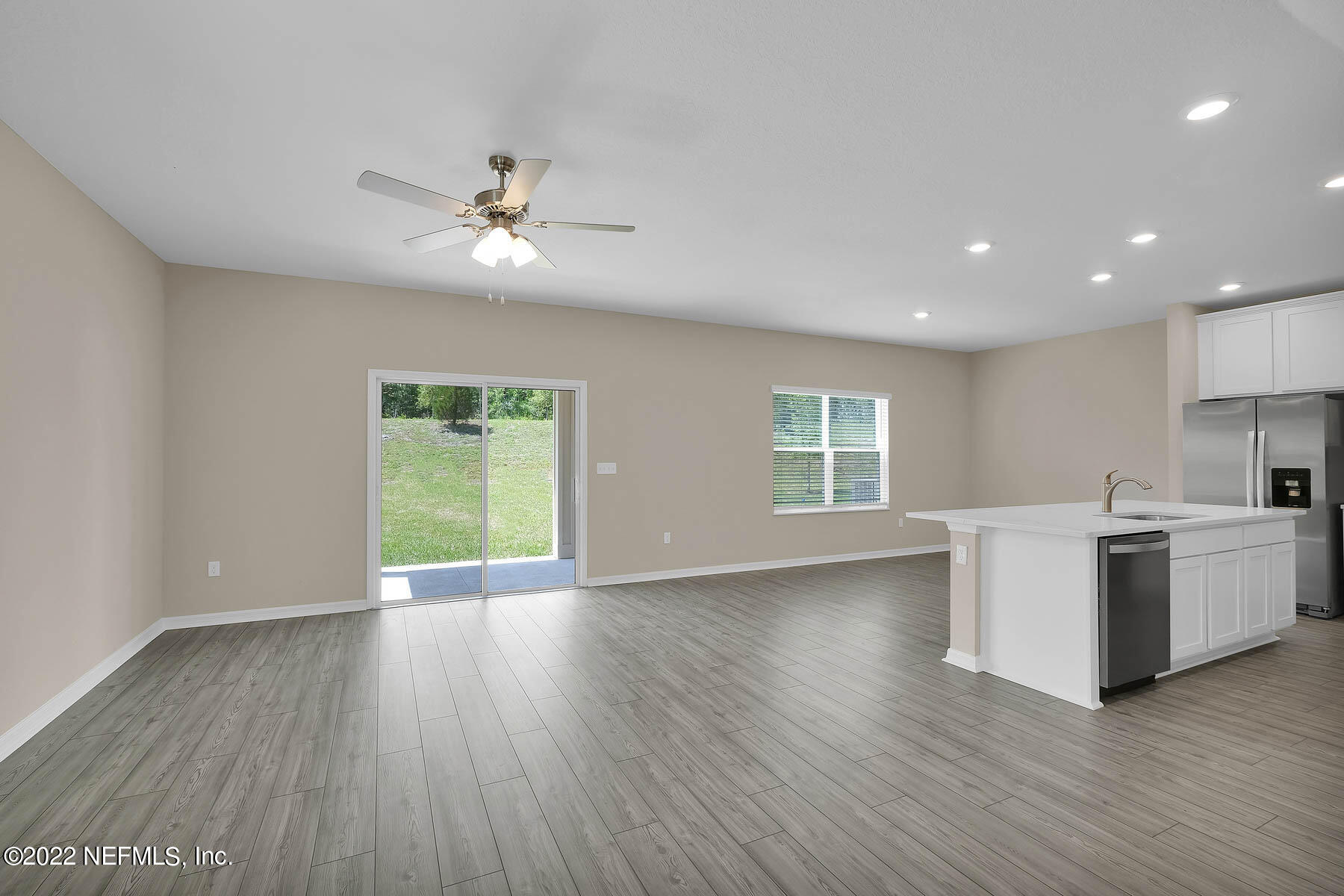 486 Falcon Ridge Road St. Augustine, FL 32084 - Photo 3 of 12 a view of an empty room with a window and wooden floor