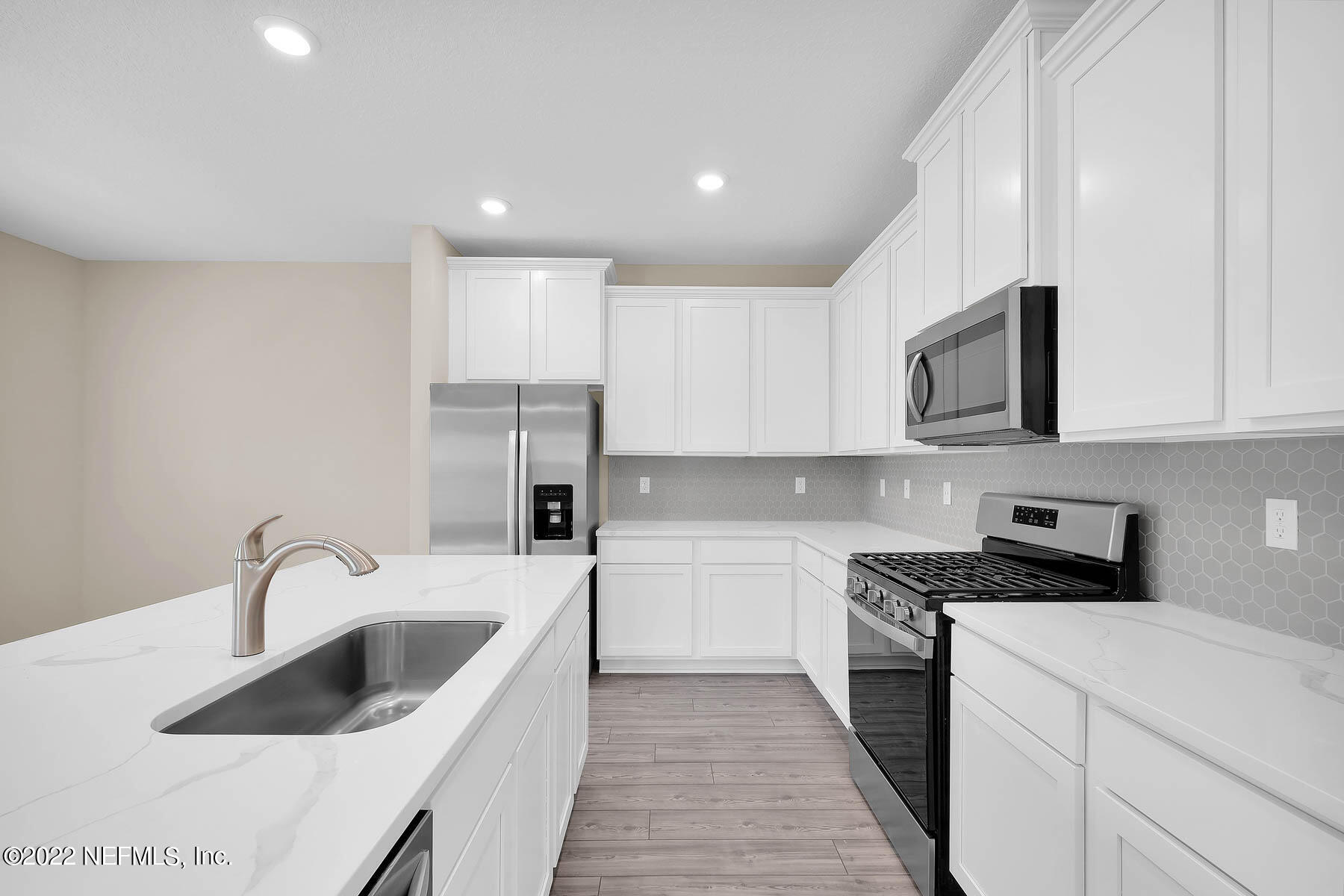 486 Falcon Ridge Road St. Augustine, FL 32084 - Photo 6 of 12 a kitchen that has a sink and a stove top oven