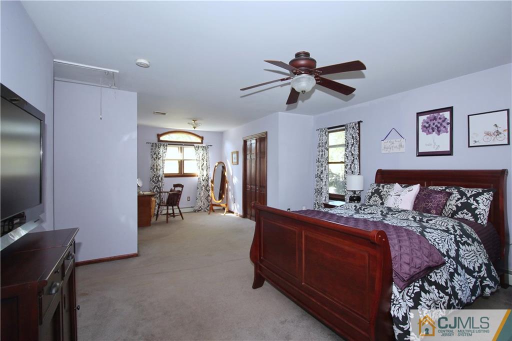 60 Morningside Road Colonia, NJ 07067 - Photo 14 of 21 a bedroom with bed and a flat tv screen on dresser
