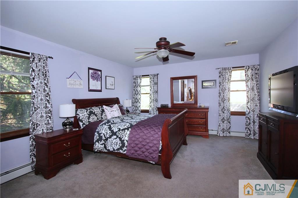 60 Morningside Road Colonia, NJ 07067 - Photo 15 of 21 a bed room with furniture and a flat screen tv