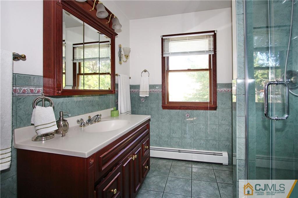 60 Morningside Road Colonia, NJ 07067 - Photo 17 of 21 a bathroom with a sink and a mirror