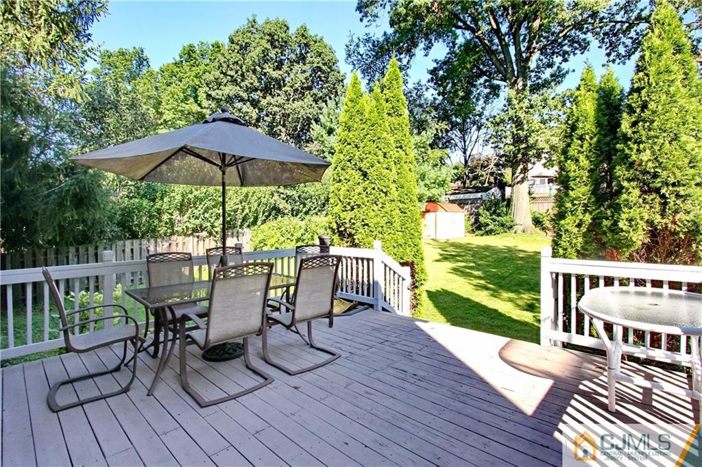 60 Morningside Road Colonia, NJ 07067 - Photo 19 of 21 a view of a chairs and table on the wooden deck