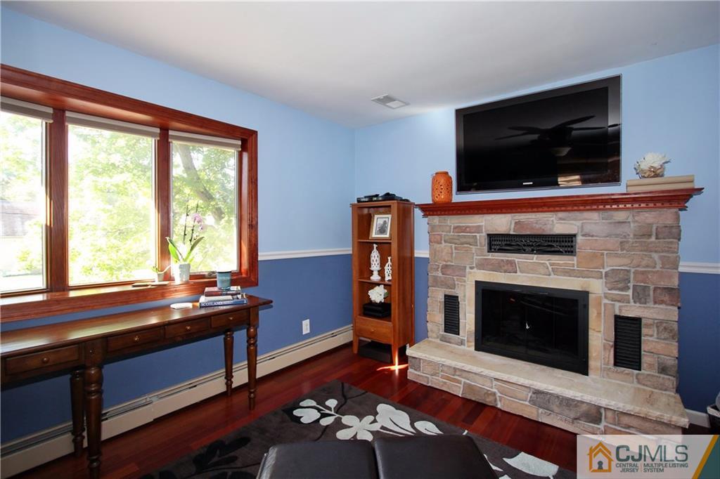 60 Morningside Road Colonia, NJ 07067 - Photo 3 of 21 a living room with furniture and a fireplace