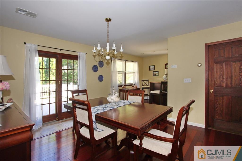 60 Morningside Road Colonia, NJ 07067 - Photo 6 of 21 a view of a dining room with furniture wooden floor and chandelier