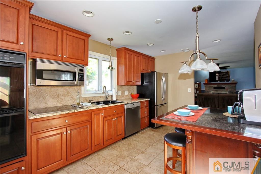 60 Morningside Road Colonia, NJ 07067 - Photo 9 of 21 a kitchen with granite countertop stainless steel appliances and wooden cabinets