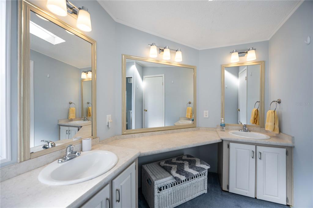 15550 Burnt Store Road, Unit 22 Punta Gorda, FL 33955 - Photo 13 of 39 a bathroom with a sink double vanity and a mirror