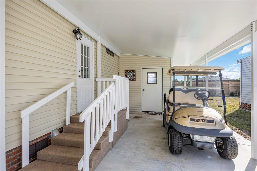 15550 Burnt Store Road, Unit 22 Punta Gorda, FL 33955 - Photo 2 of 39 a balcony with couple of chairs and a potted plant