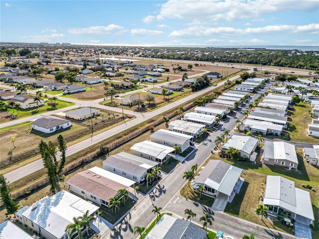 15550 Burnt Store Road, Unit 22 Punta Gorda, FL 33955 - Photo 24 of 39 an aerial view of a city with lots of residential buildings ocean and mountain view in back