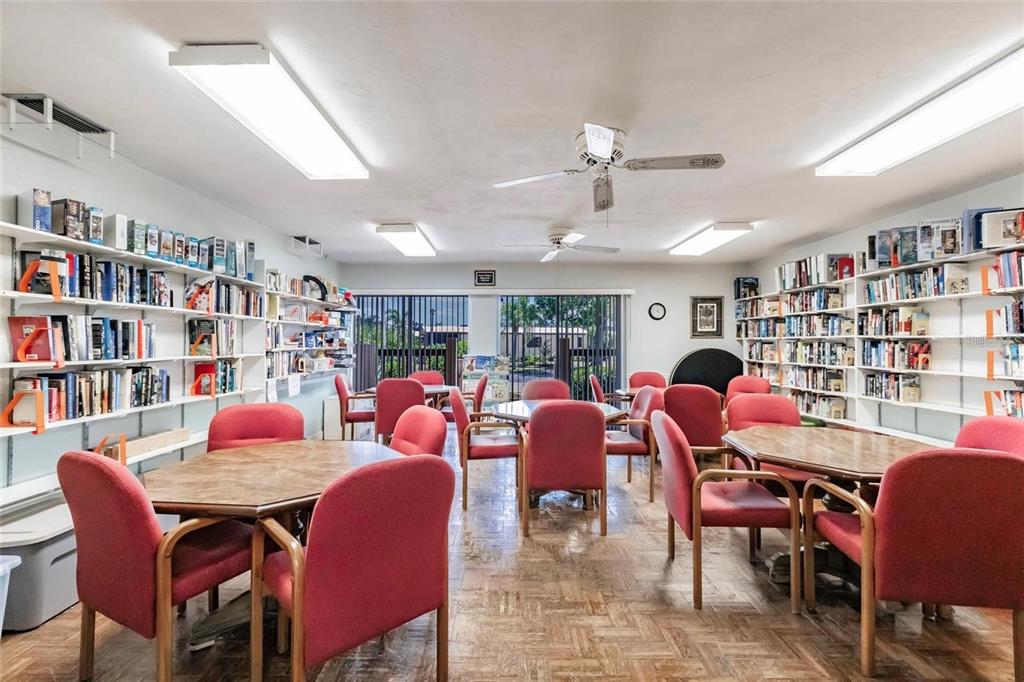 15550 Burnt Store Road, Unit 22 Punta Gorda, FL 33955 - Photo 30 of 39 a room with lots of furniture and a book shelf