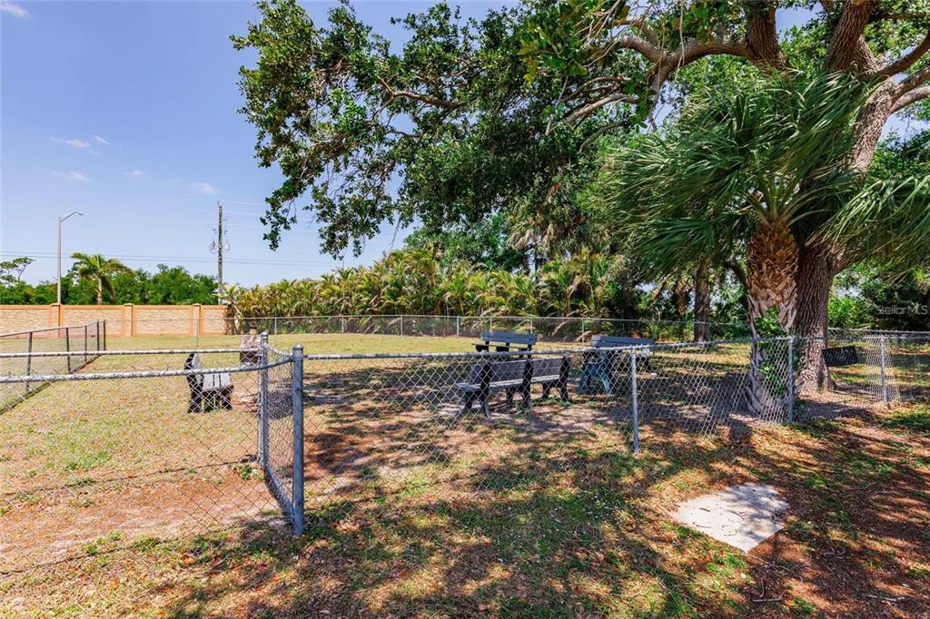15550 Burnt Store Road, Unit 22 Punta Gorda, FL 33955 - Photo 39 of 39 a view of a lake with a bench and trees