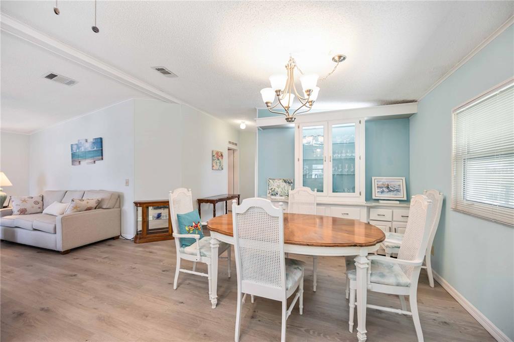 15550 Burnt Store Road, Unit 22 Punta Gorda, FL 33955 - Photo 7 of 39 a view of a dining room with furniture and wooden floor