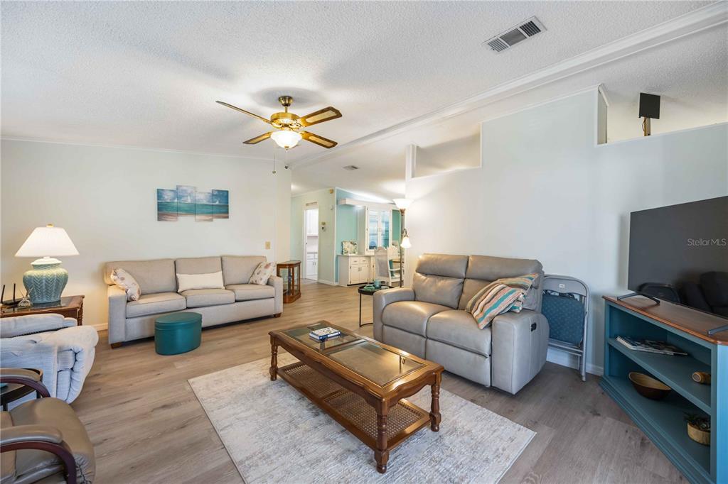 15550 Burnt Store Road, Unit 22 Punta Gorda, FL 33955 - Photo 9 of 39 a living room with furniture a flat screen tv and a lamp