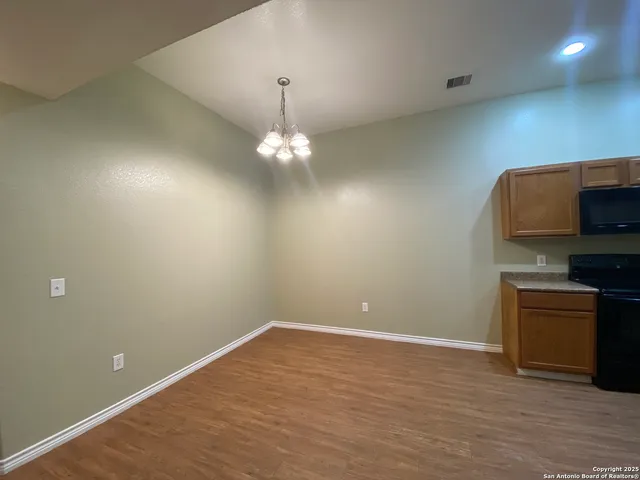 a view of a kitchen with a dishwasher cabinets and a wooden floor