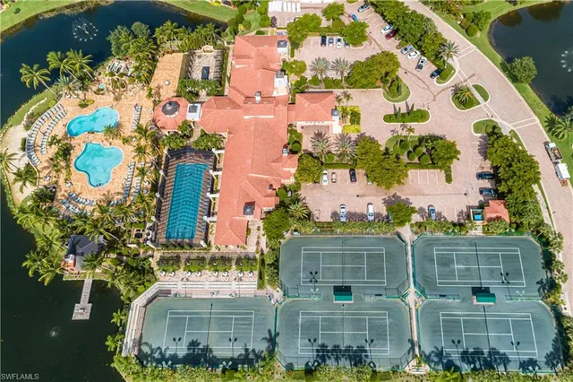 an aerial view of residential houses with outdoor space and lake view