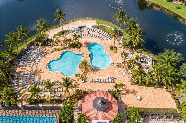 an aerial view of residential houses with outdoor space and lake view